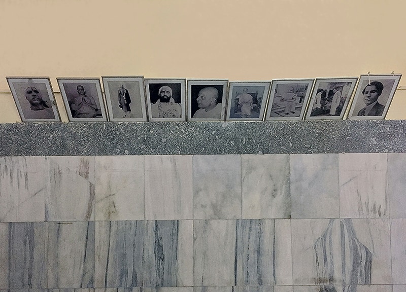 Photos of Swami Kripalvananda (Swami Kripalu) displayed along the left wall in his Birth Home Memorial.