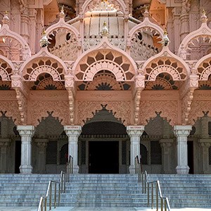 Front of ornate building in India, with stairs leading up to it.