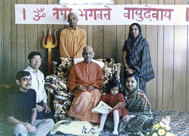 Ramesh and Neeta Panchal's Home in Nebraska. (Left to right) Bhogilal Panchal, Ramesh Panchal, Swami Vinit Muni (standing), Bapuji (Swami Kripalvananda, Swami Kripalu), Susmita Panchal (daughter), Neeta Panchal, Urmila Desai (standing)