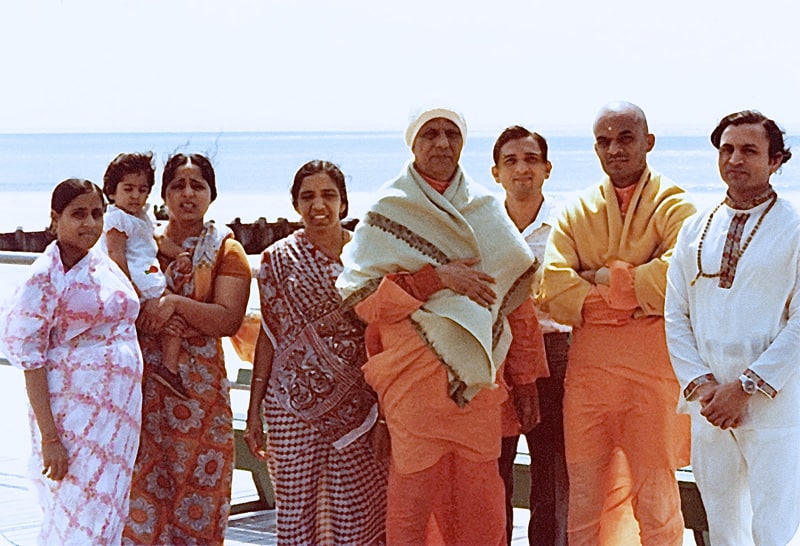 Swami Kripalvanda (Swami Kripalu) with a group on the boardwalk by the Atlantic Ocean. Ocean City, New Jersey.