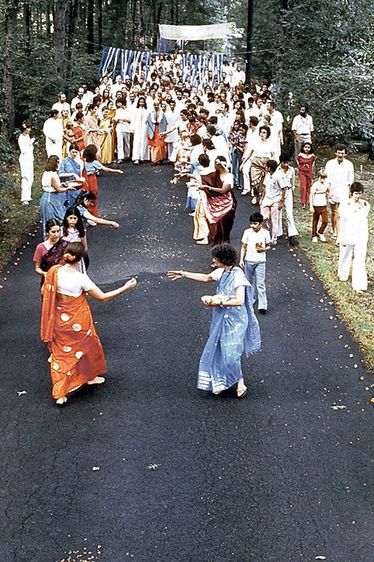 Arrival in America. Celebration – Swami Kripalvananda (Swami Kripalu) walking from his living quarters, Rajeshwari, to Sadhana Mandir.