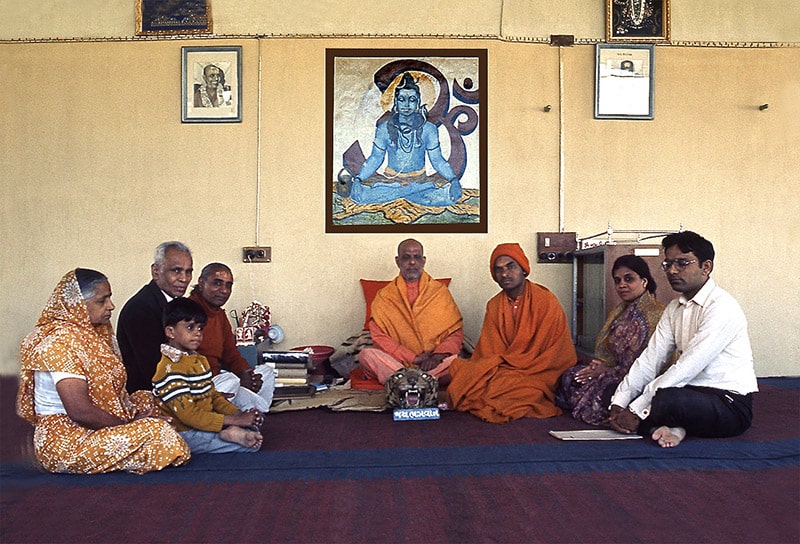 Brahmeshvara Jyotirshivalinga Temple. January 1972 at Swami Kripalu's 3 PM Darshan time. (From Left to Right) Radhaba C. Panchal, Himal B. Panchal (son of Veena & Bhupen Panchal), Chunilal Panchal, Unknown, Swami Kripalvananda, Swami Vinit Muni, Veena B. Panchal, and Bhupen C. Panchal.