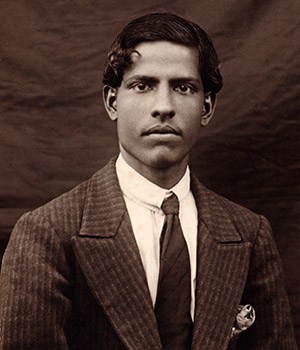 Portrait of Swami Kripalvananda as a young man, wearing a suit.