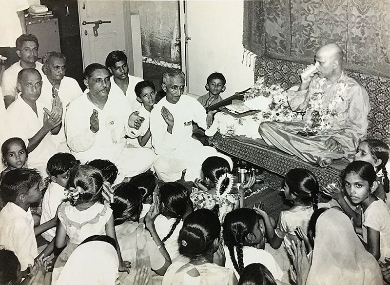 Ramanbhai Patel's Home Photo of Swami Kripalvananda (Swami Kripalu). Ramanbhai Chhotabhai Patel's home in Borivali, a suburb of Mumbai. 1967. Kirtan/Satsanga: (Left to Right) Nanubhai Desai, Chimanbhai, Ramanbhai Patel